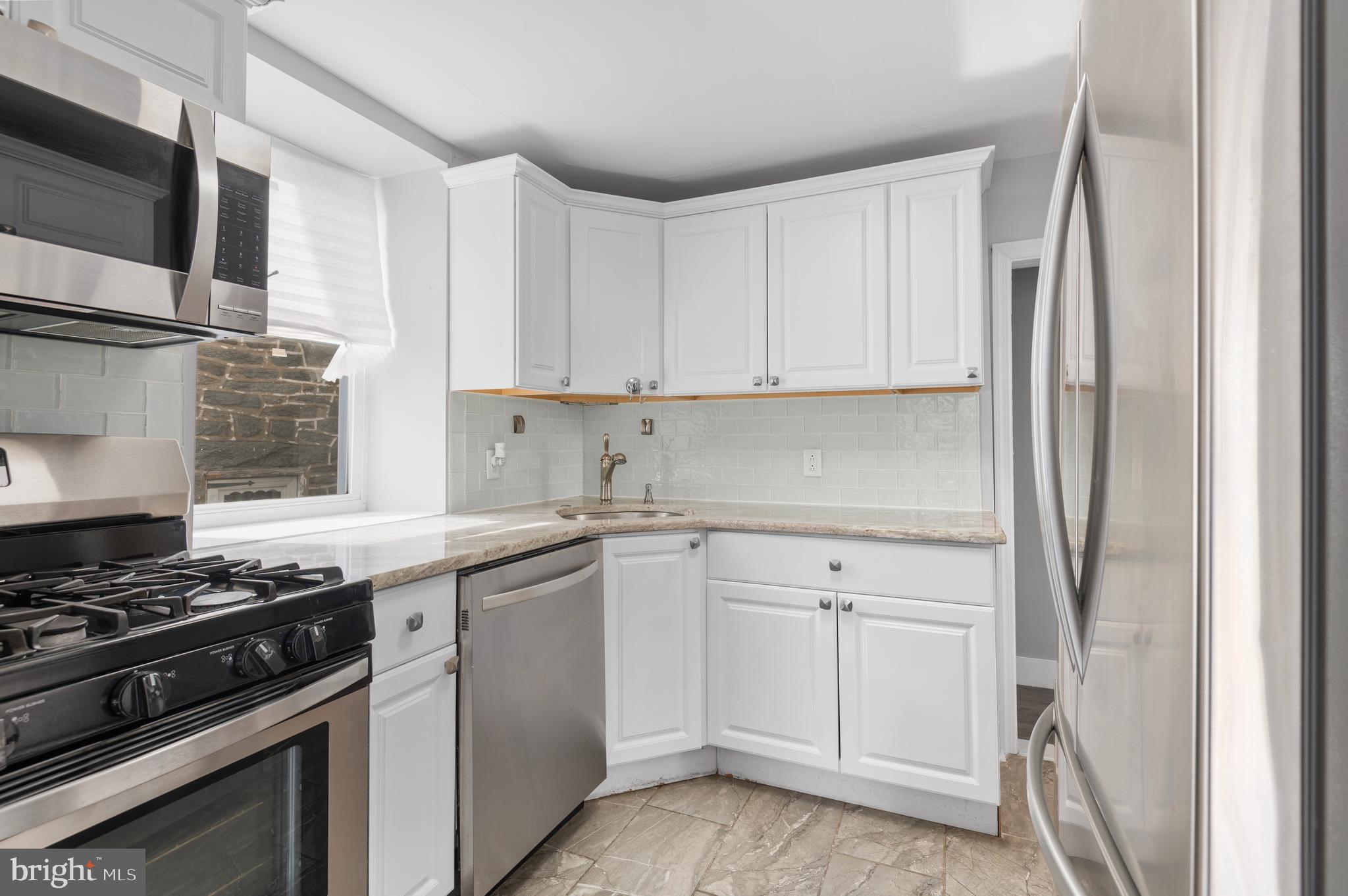 7 Harvin Road Upper Darby, PA 19082 - Photo 8 of 27 a kitchen with white cabinets and appliances
