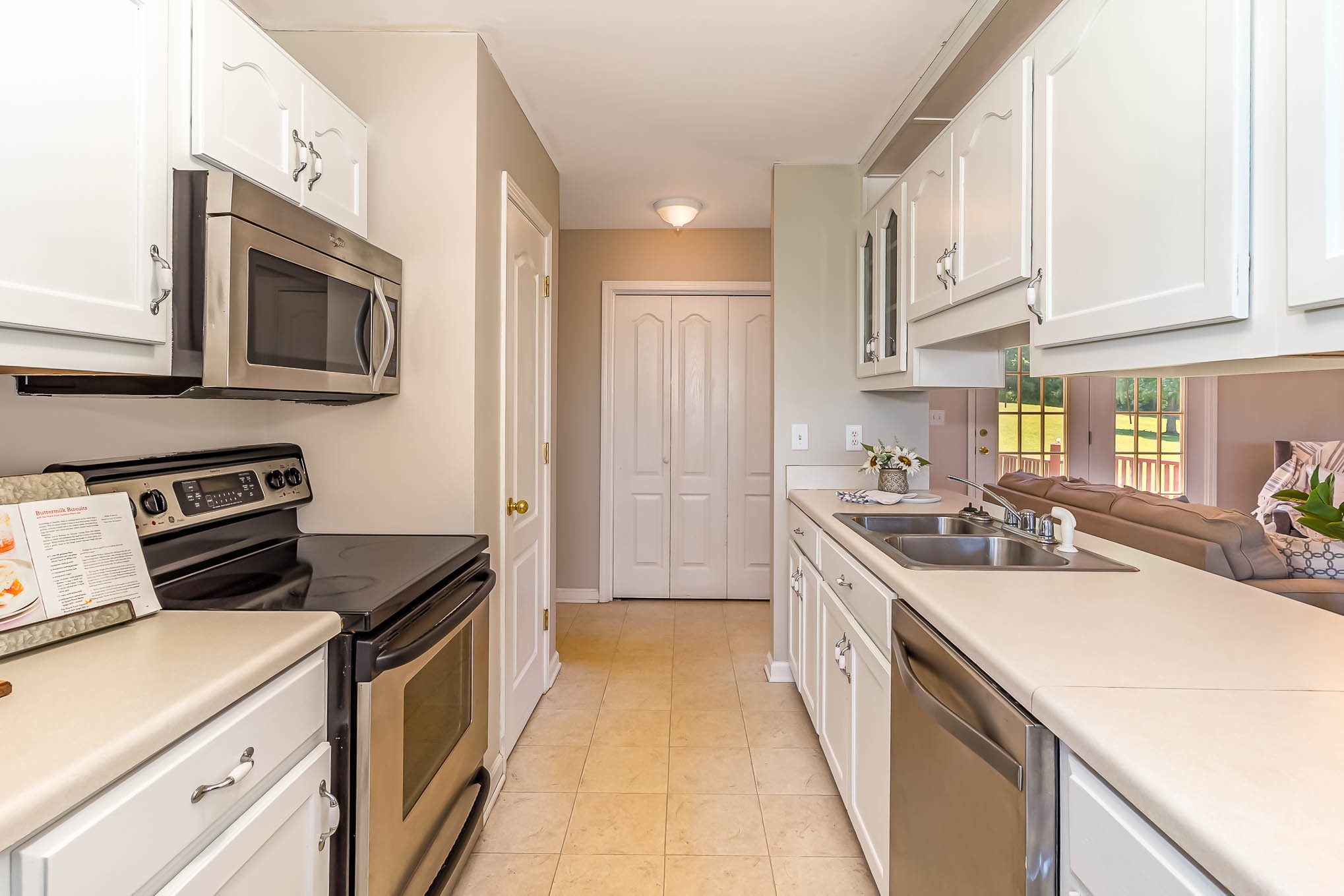 523 D V Circle Spring Hill, TN 37174 - Photo 12 of 25 a kitchen with stainless steel appliances a stove sink microwave and cabinets