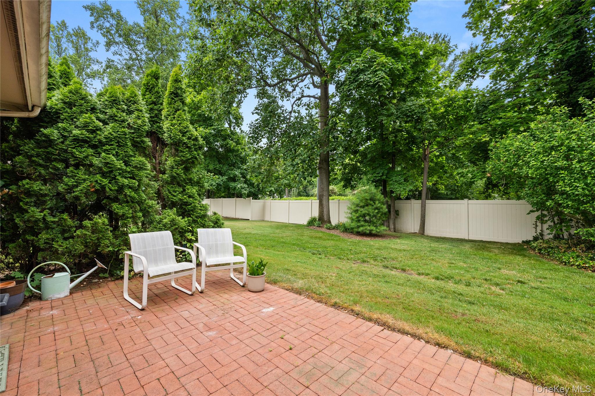 34 Cedar Ridge Lane Bay Shore, NY 11706 - Photo 21 of 27 a white bench sitting in the middle of a garden