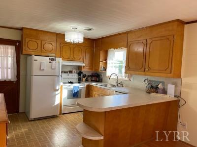 2548 Halifax Road Chatham, VA 24531 - Photo 7 of 21 a kitchen with a refrigerator sink and cabinets
