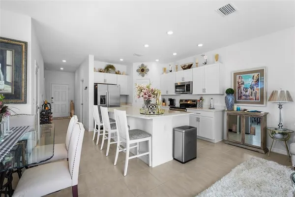 a living room with furniture kitchen view and a dining table