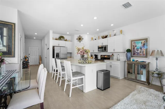 a living room with furniture kitchen view and a dining table
