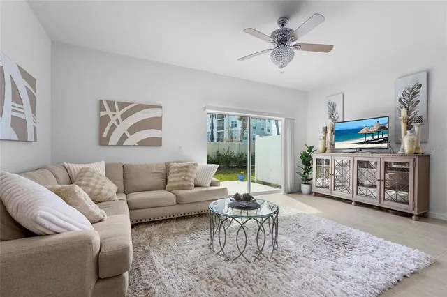 a spacious bedroom with a bed and a chandelier