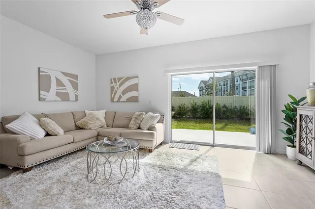 a bed room with a bed and a ceiling fan