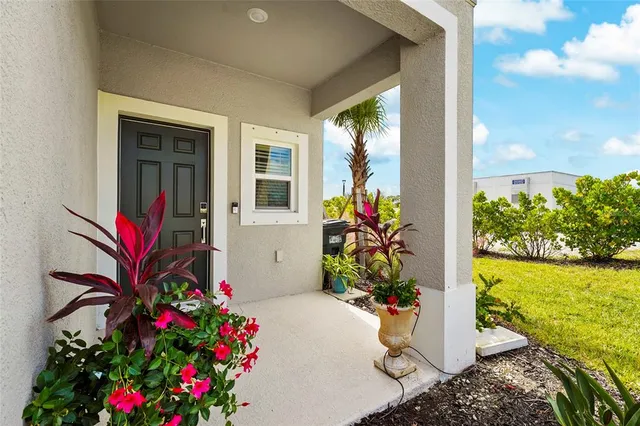 a kitchen with stainless steel appliances a table chairs refrigerator and microwave