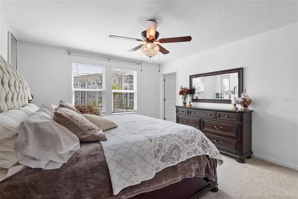 a bedroom with a bed and a mirror