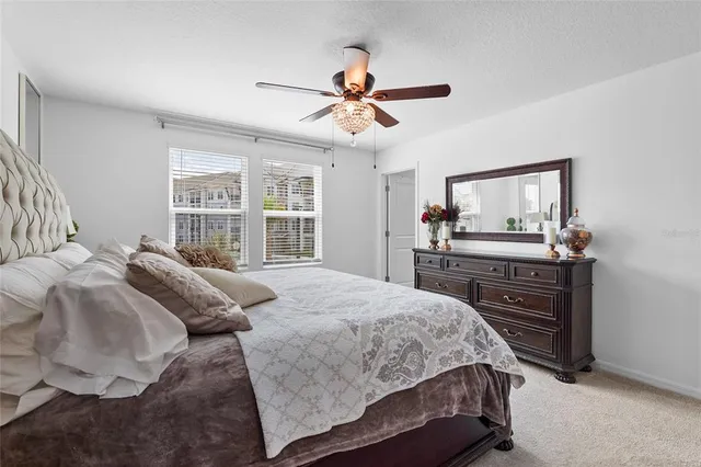 a bedroom with a bed and a mirror