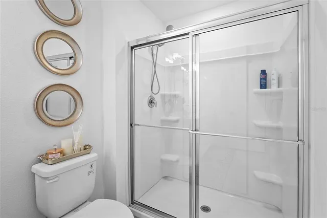 a view of a chair and fire pit in front of house