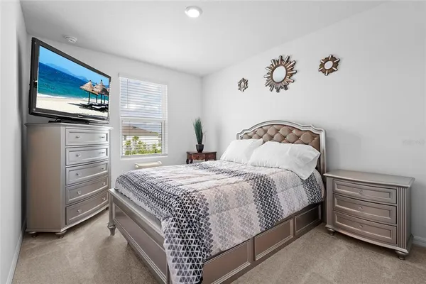 a view of a white house with a yard and sitting area