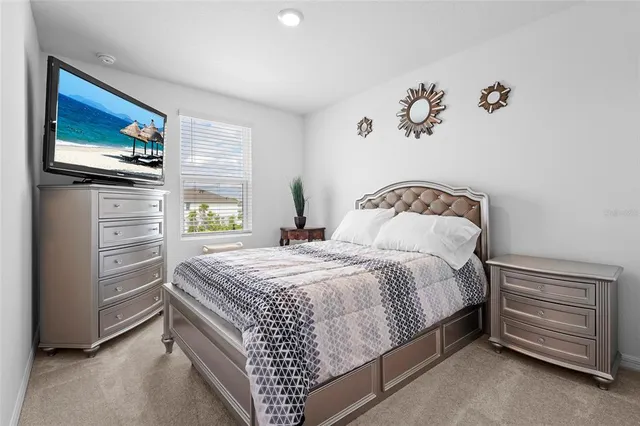 a view of a white house with a yard and sitting area