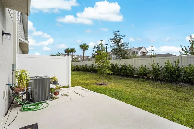 a view of a house with swimming pool and sitting area