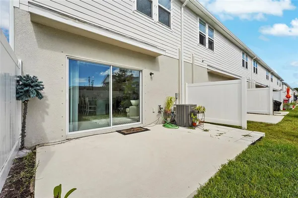 a view of a patio with a table and chairs under an umbrella