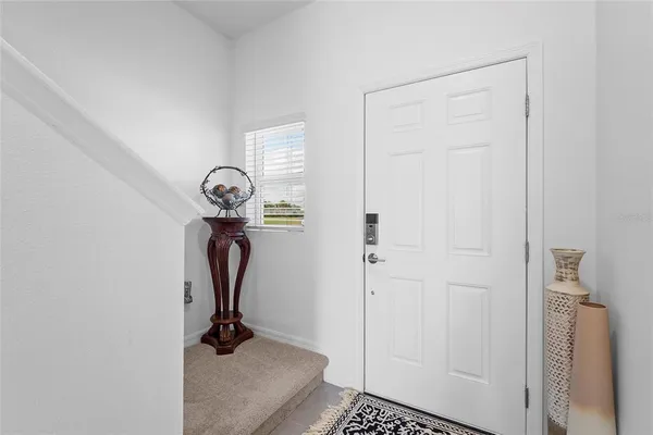 a kitchen with counter space a sink and living room view