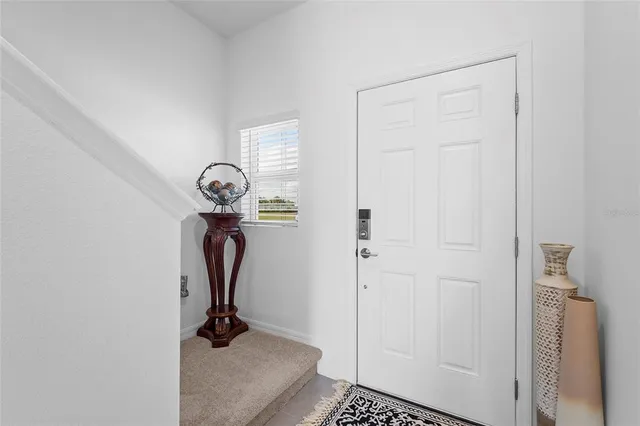 a kitchen with counter space a sink and living room view