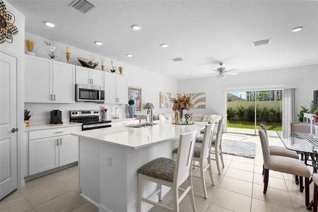 a kitchen with stainless steel appliances granite countertop a refrigerator and a stove top oven
