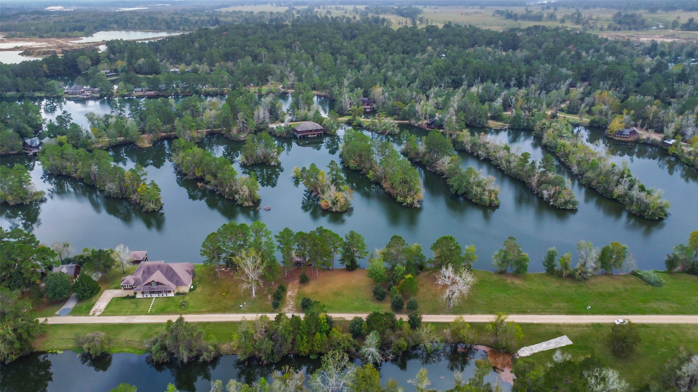 17-16 A Smith Loop North Cleveland, TX 77327 - Photo 17 of 38 an aerial view of a house with a yard and lake view