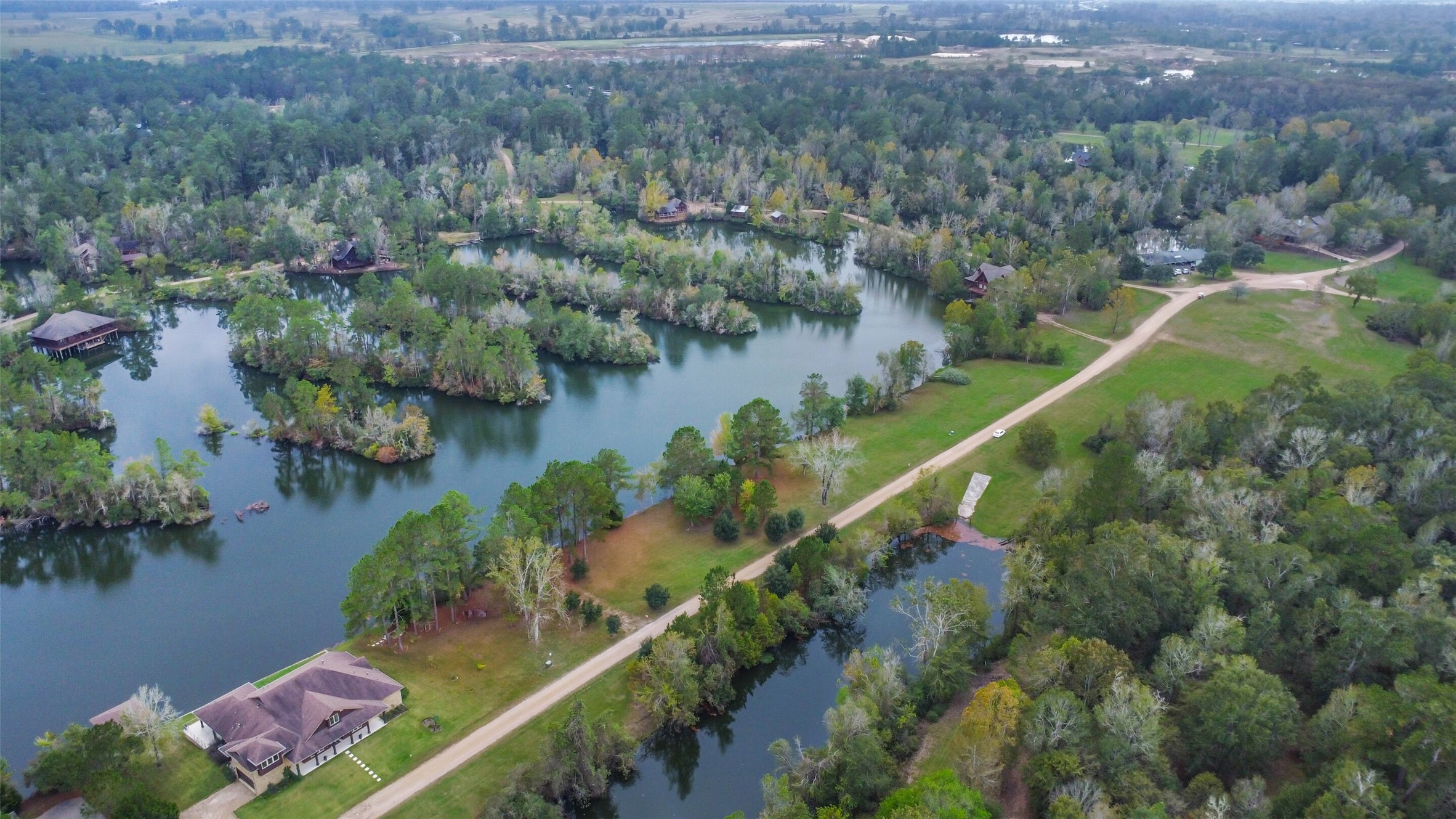 17-16 A Smith Loop North Cleveland, TX 77327 - Photo 18 of 38 an aerial view of residential house with outdoor space and lake view