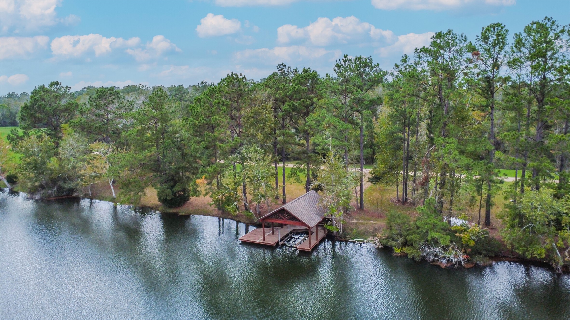 17-16 A Smith Loop North Cleveland, TX 77327 - Photo 22 of 38 an aerial view of a house with swimming pool and lake view