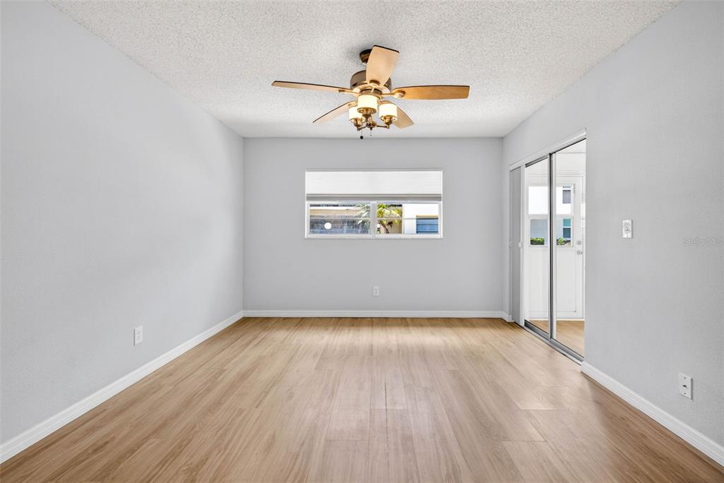 5197 Silent Loop, Unit 124 New Port Richey, FL 34652 - Photo 31 of 55 wooden floor in an empty room with a window