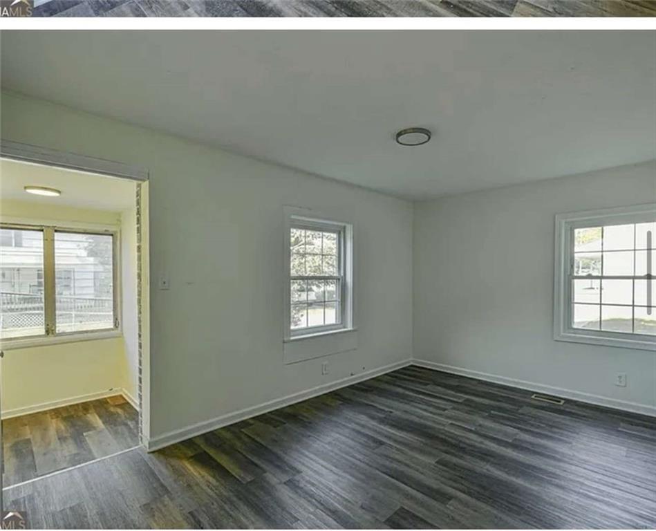 24 East Main Street Gainesville, GA 30501 - Photo 11 of 14 an empty room with wooden floor and windows