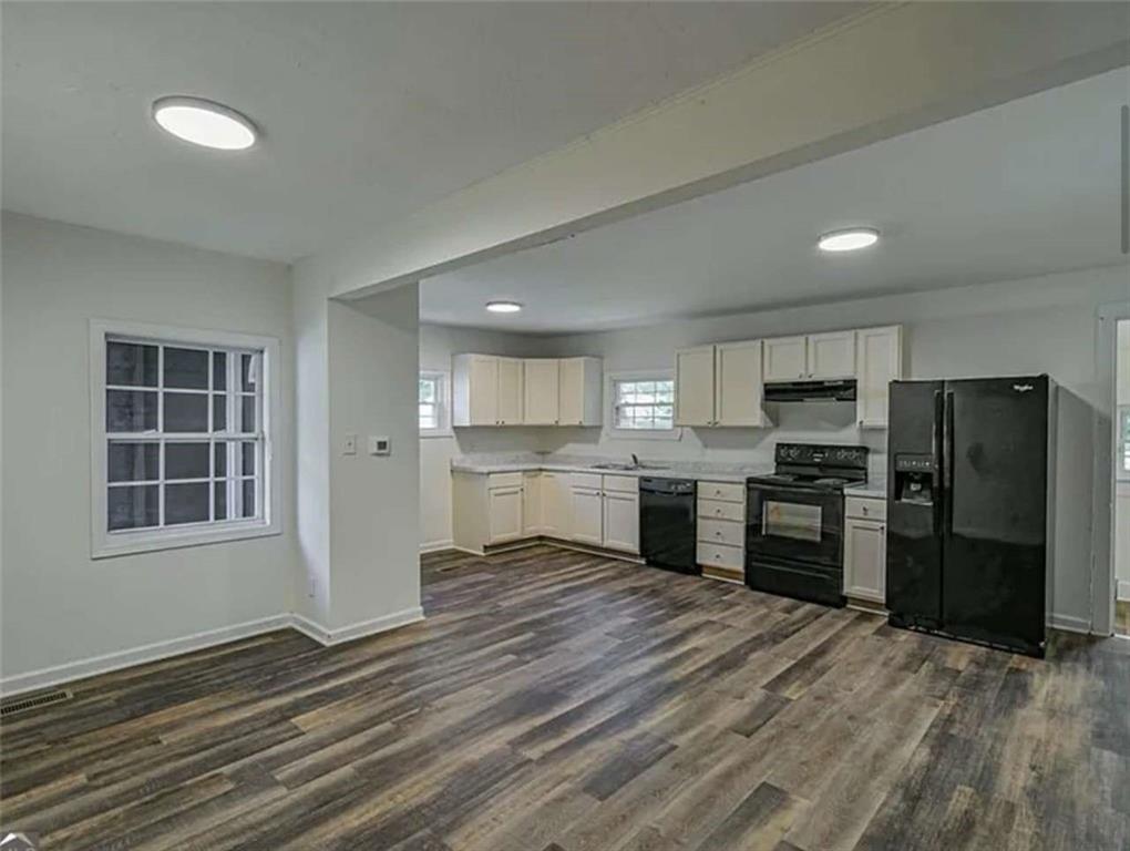 24 East Main Street Gainesville, GA 30501 - Photo 3 of 14 a large kitchen with a refrigerator and a stove top oven