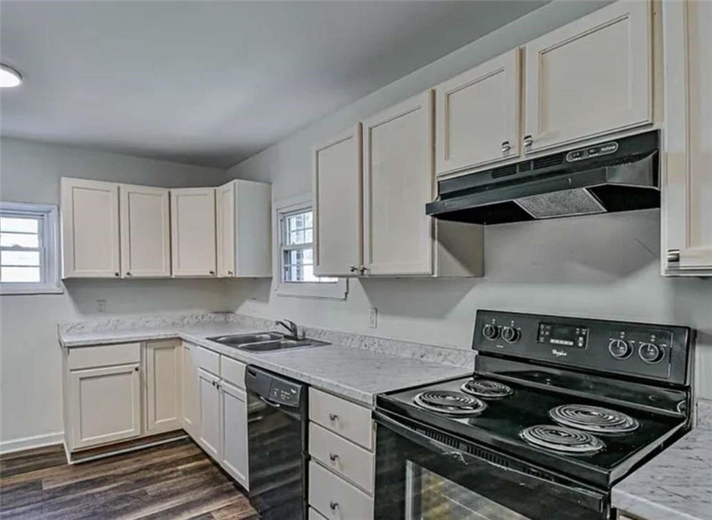 24 East Main Street Gainesville, GA 30501 - Photo 4 of 14 a kitchen with granite countertop stainless steel appliances and white cabinets