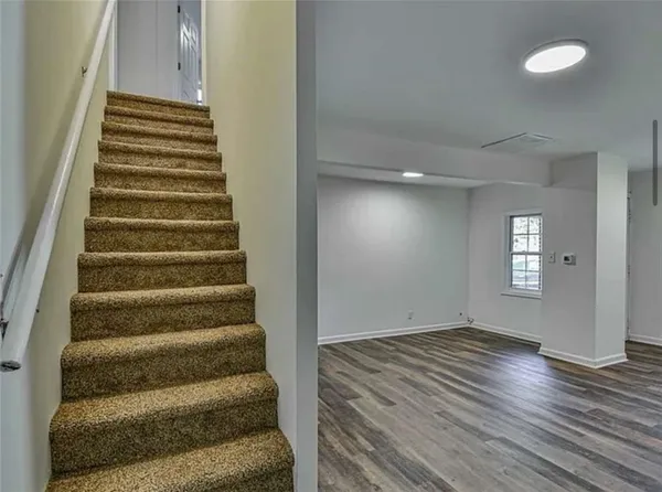 a view of entryway and hall with wooden floor