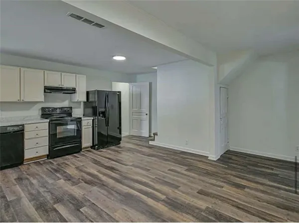 a kitchen with stainless steel appliances a refrigerator and a stove top oven