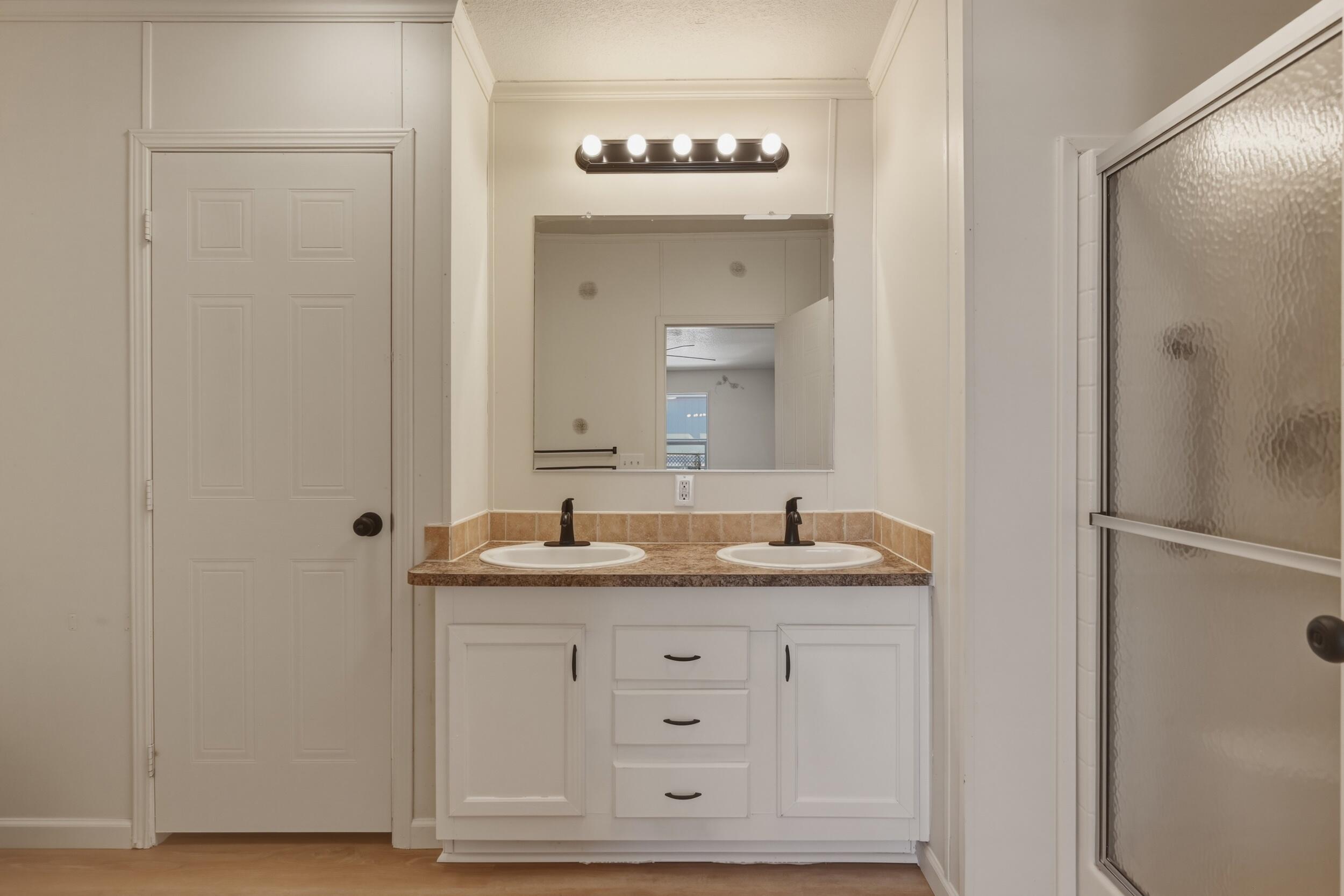 312 East Cedar Milll Road Star Valley, AZ 85541 - Photo 22 of 27 a bathroom with a granite countertop sink and a mirror