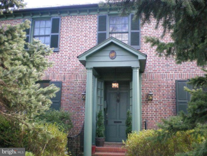 a front view of a house with plants