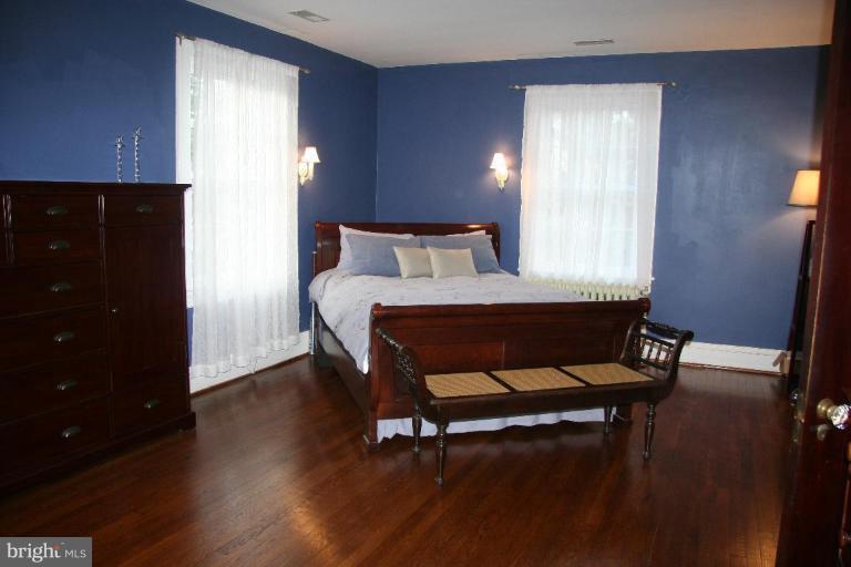 1503 Frederick Road Catonsville, MD 21228 - Photo 14 of 23 a bedroom with a bed and wooden floor
