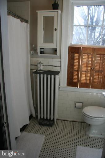 1503 Frederick Road Catonsville, MD 21228 - Photo 16 of 23 a bathroom with a window and a toilet