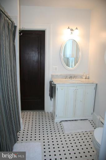 1503 Frederick Road Catonsville, MD 21228 - Photo 17 of 23 a bathroom with a sink a toilet and a mirror