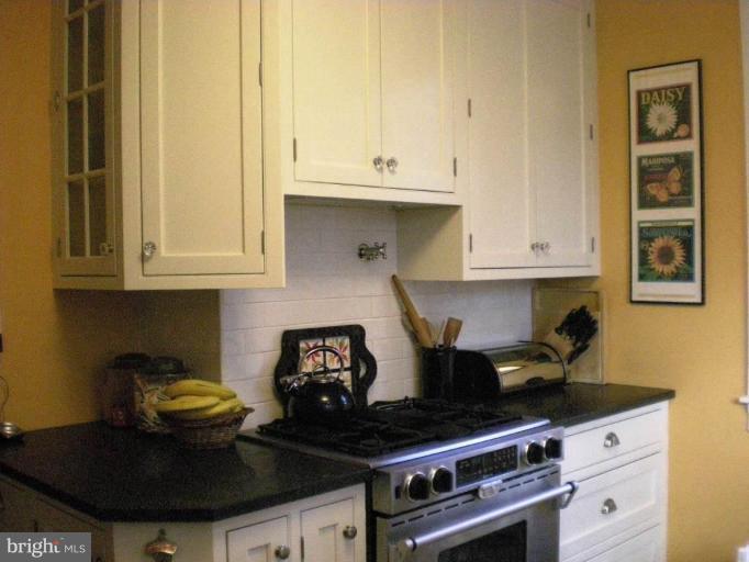 1503 Frederick Road Catonsville, MD 21228 - Photo 21 of 23 a kitchen with stainless steel appliances granite countertop a stove and cabinets