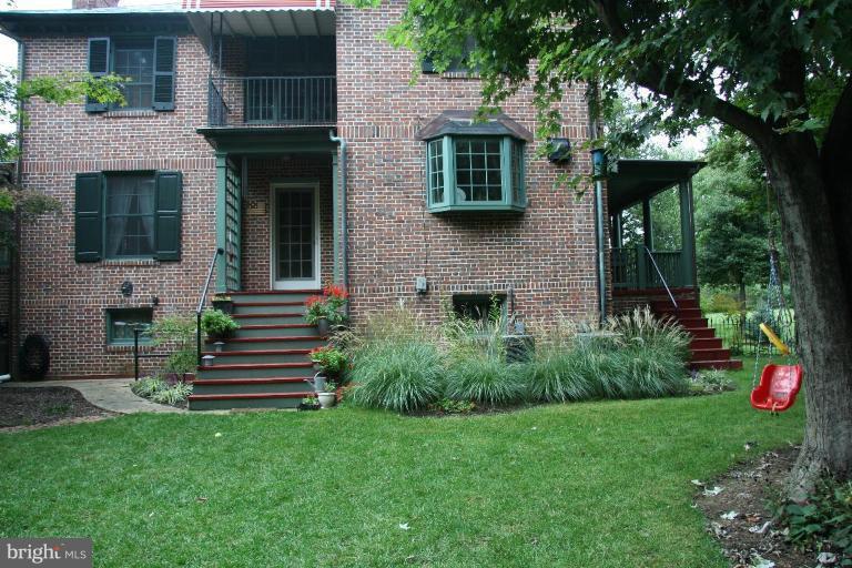 1503 Frederick Road Catonsville, MD 21228 - Photo 4 of 23 a front view of a house with a yard and a garden
