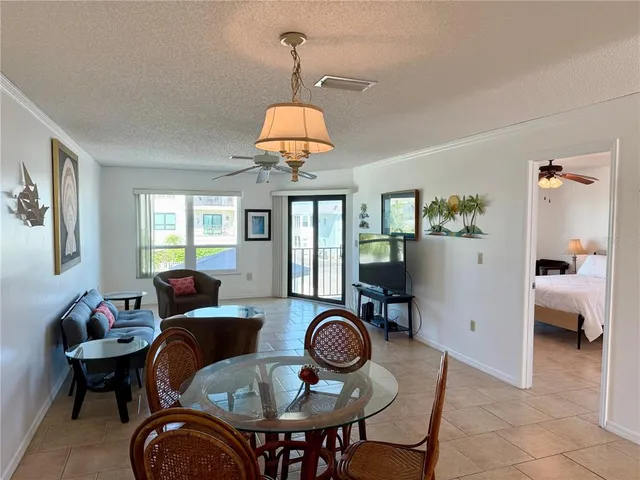 a view of a dining room with furniture wooden floor and chandelier
