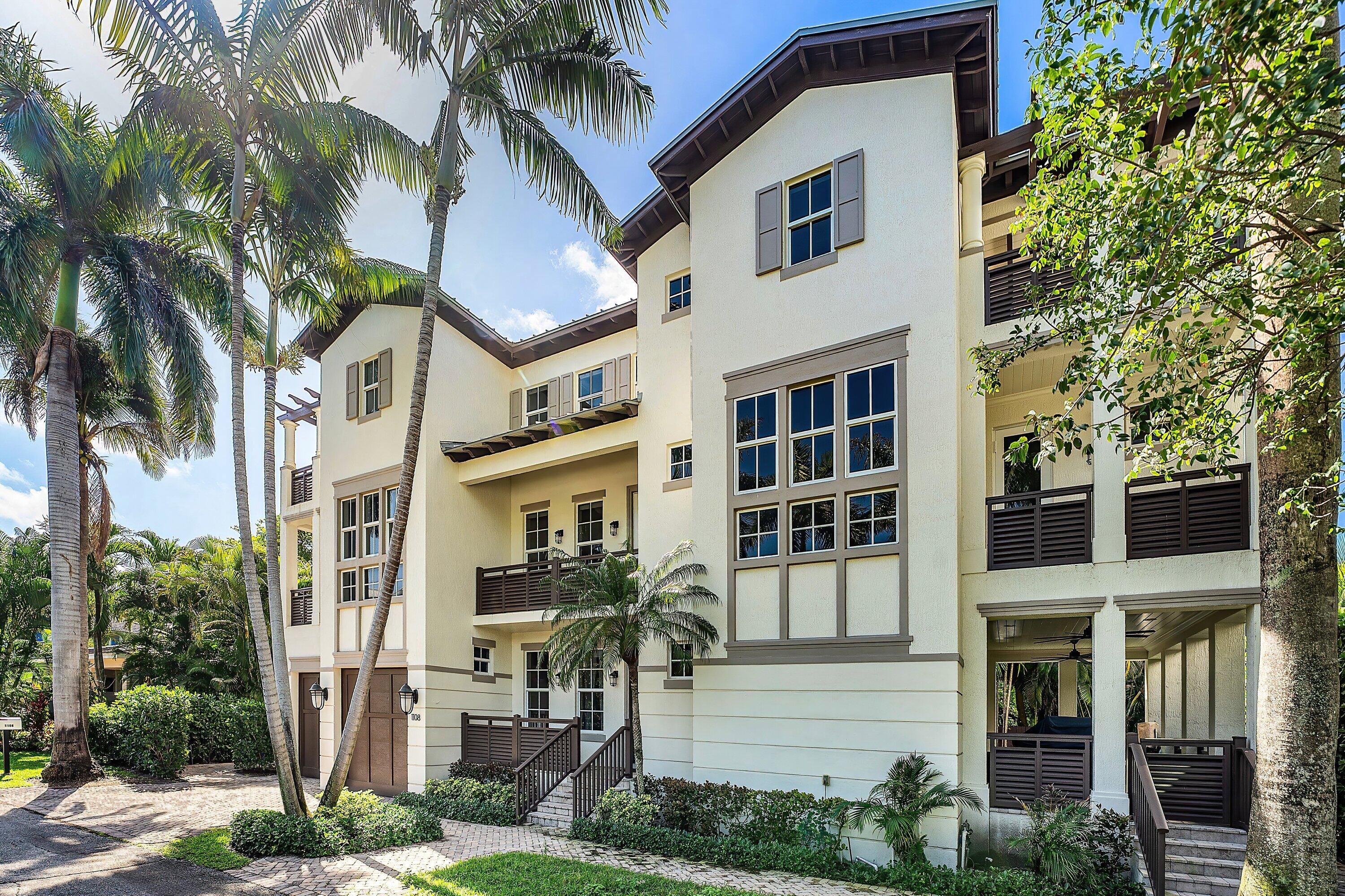 1108 Coconut Row Delray Beach, FL 33483 - Photo 14 of 31 a front view of a multi story residential apartment building with a yard and potted plants