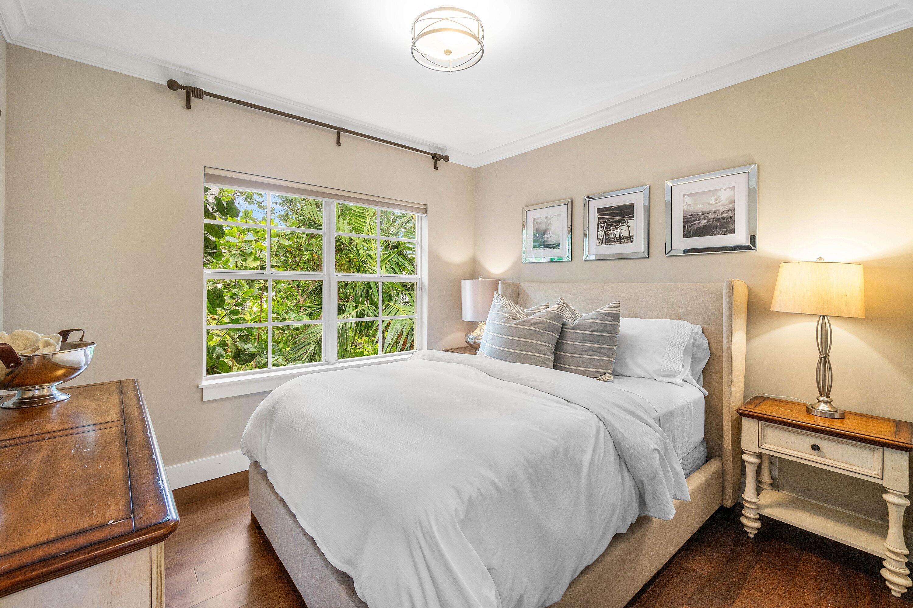 1108 Coconut Row Delray Beach, FL 33483 - Photo 22 of 31 a large bed sitting in a bedroom next to a window