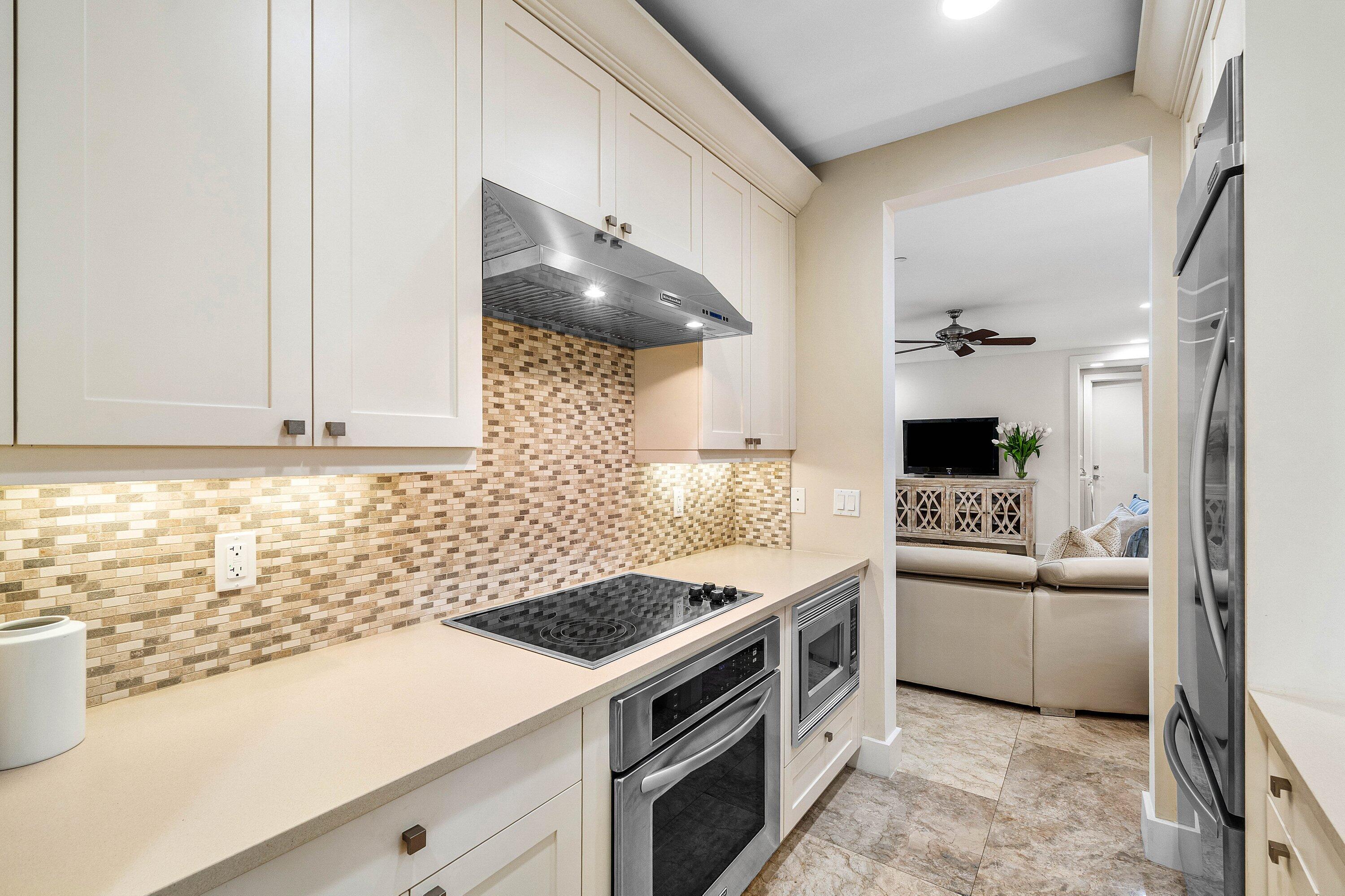 1108 Coconut Row Delray Beach, FL 33483 - Photo 24 of 31 a kitchen with a stove and a sink