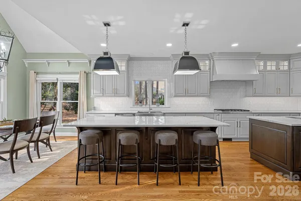 a kitchen with granite countertop a dining table and chairs
