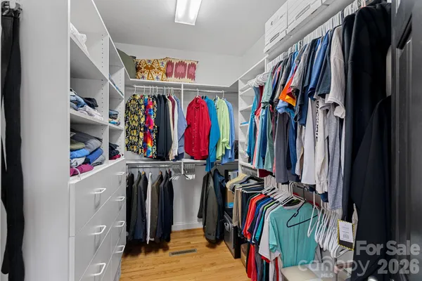 a view of walk in closet with clothes
