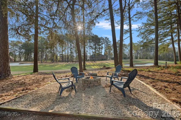 a view of a park with bench and trees