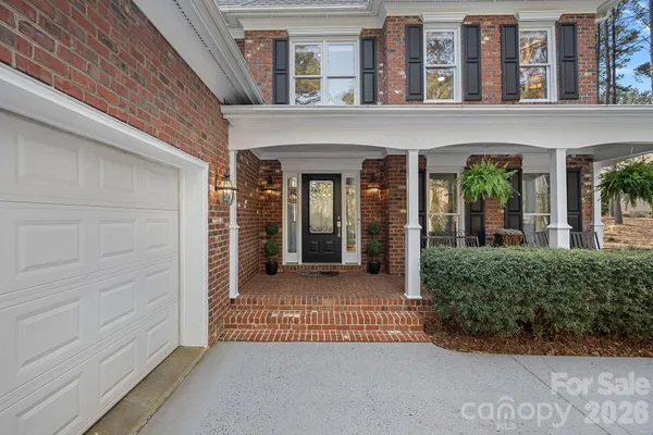 front view of a brick house with a large window