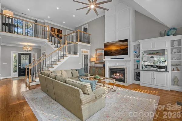 a living room with fireplace furniture and a flat screen tv