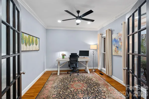 a work room with wooden floor and furniture