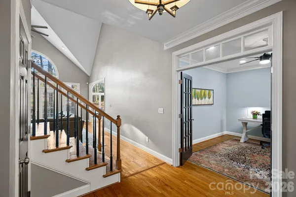 a view of hallway with stairs and wooden floor
