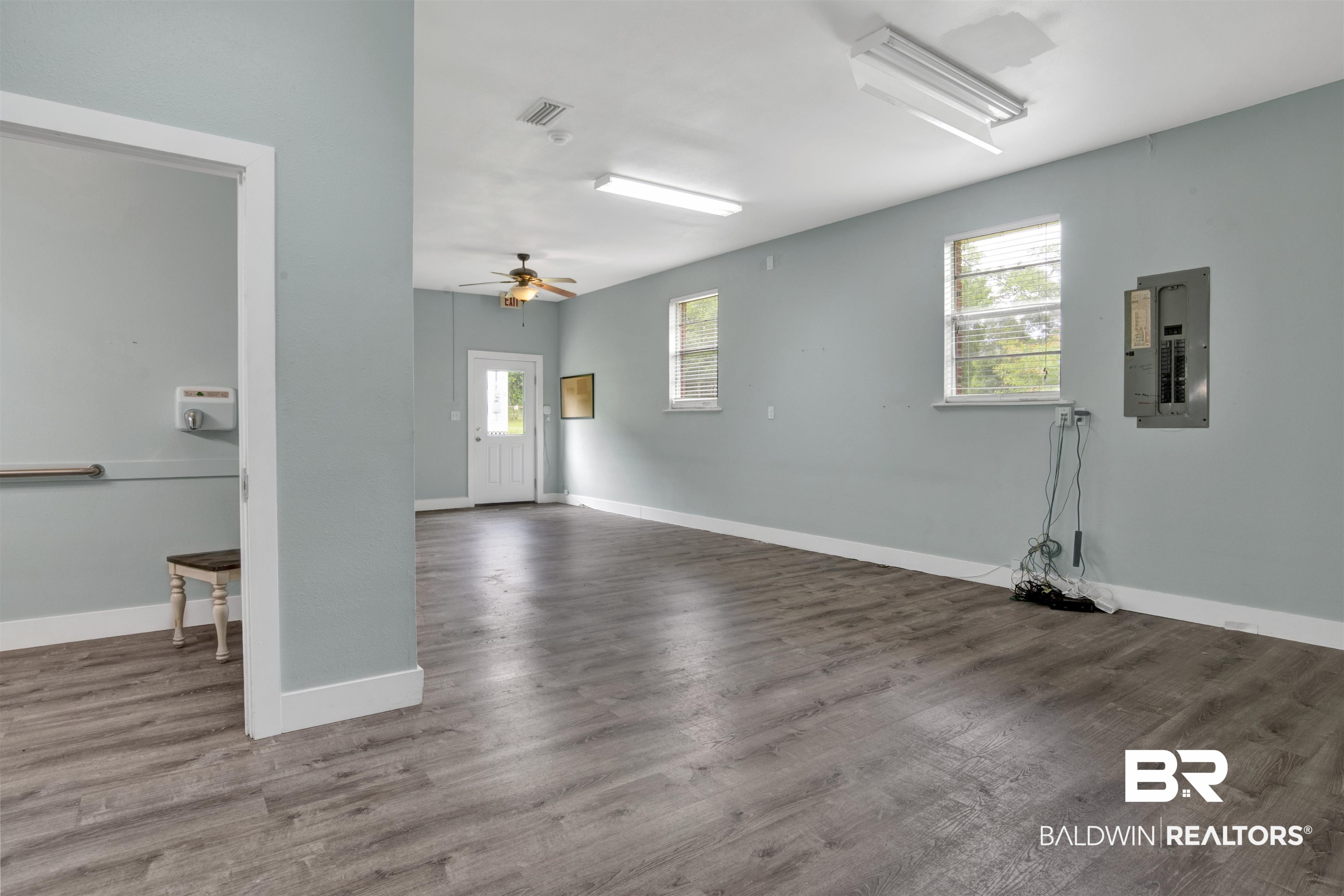 17714 Horseneck Road Bay Minette, AL 36507 - Photo 6 of 36 Spacious room featuring wood-finish flooring, light blue walls, and white trim