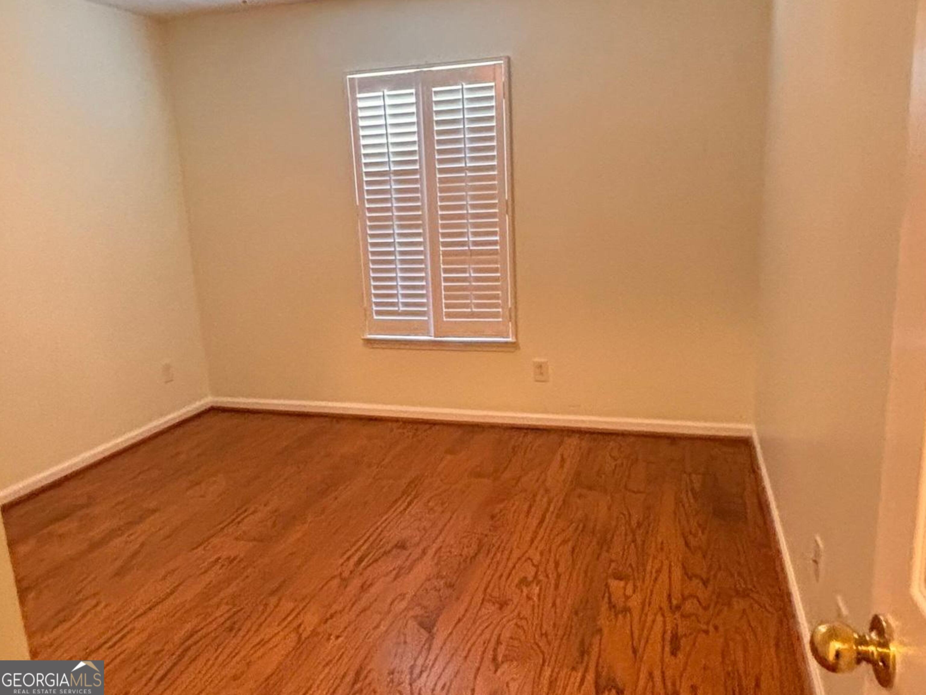 120 Cedar Bay Circle Dallas, GA 30157 - Photo 18 of 27 a view of an empty room with wooden floor and a window