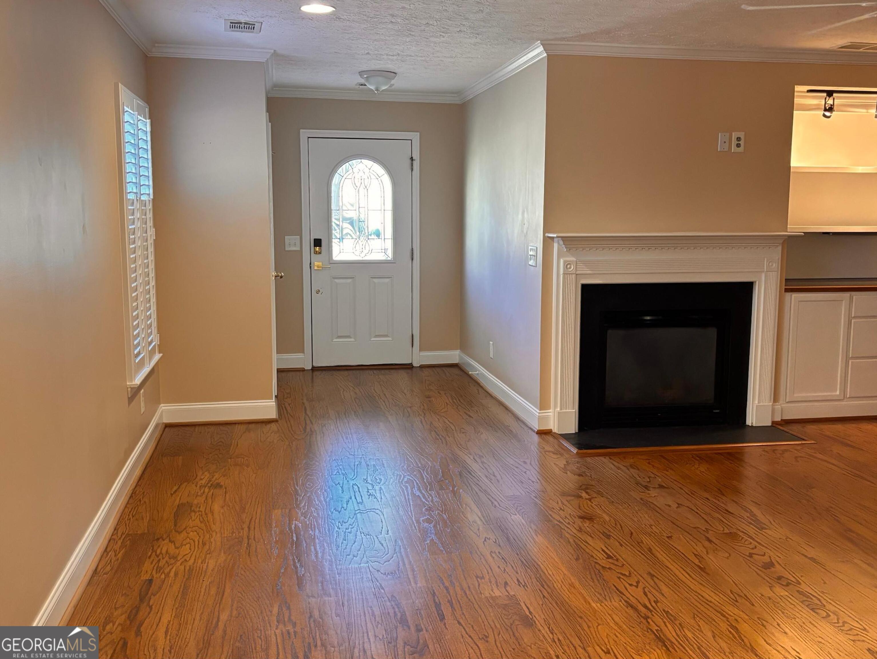 120 Cedar Bay Circle Dallas, GA 30157 - Photo 4 of 27 an empty room with wooden floor and fireplace