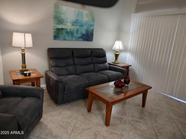 a living room with furniture and a lamp